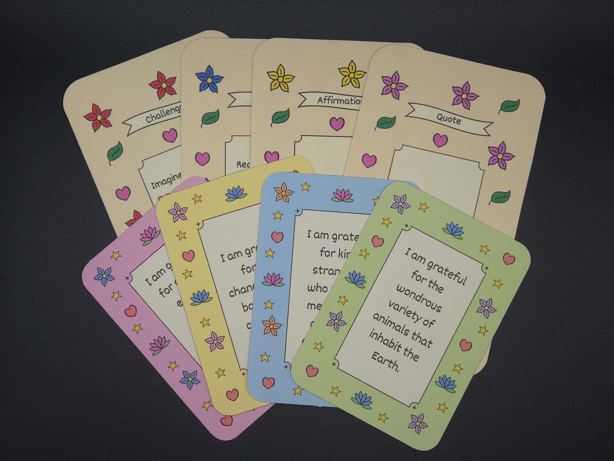 8 gratitude cards laid out in two rows with 4 in the back and 4 in the front.