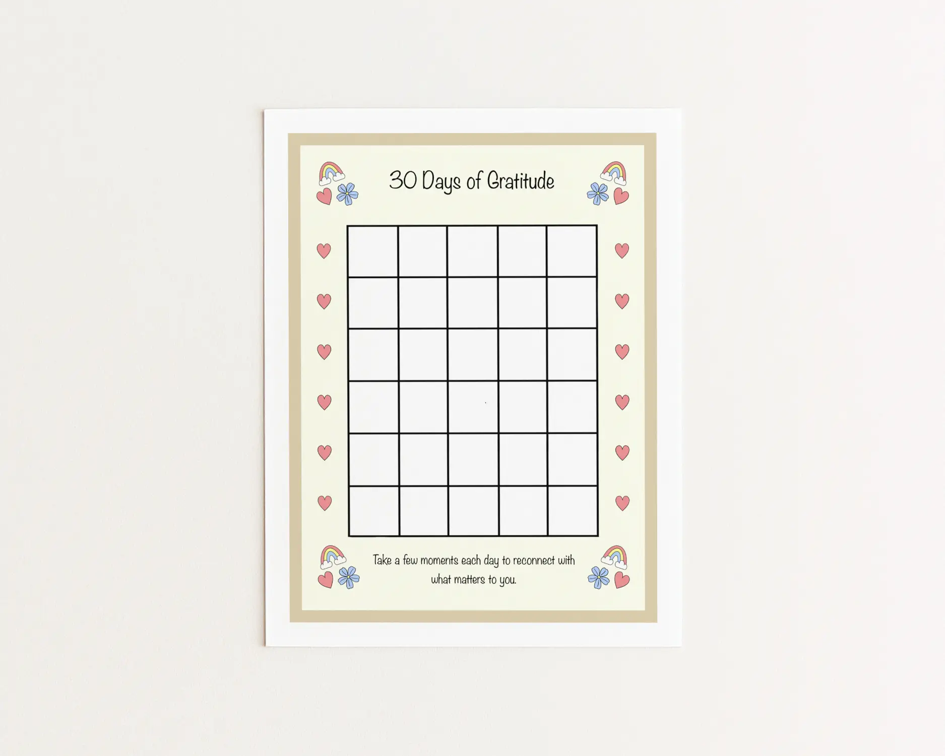 A printed page with the title "30 Days of Gratitude." It contains a central grid with space for 30 prompts. It is decorated with hand-drawn motifs of hearts, rainbows, and flowers.
