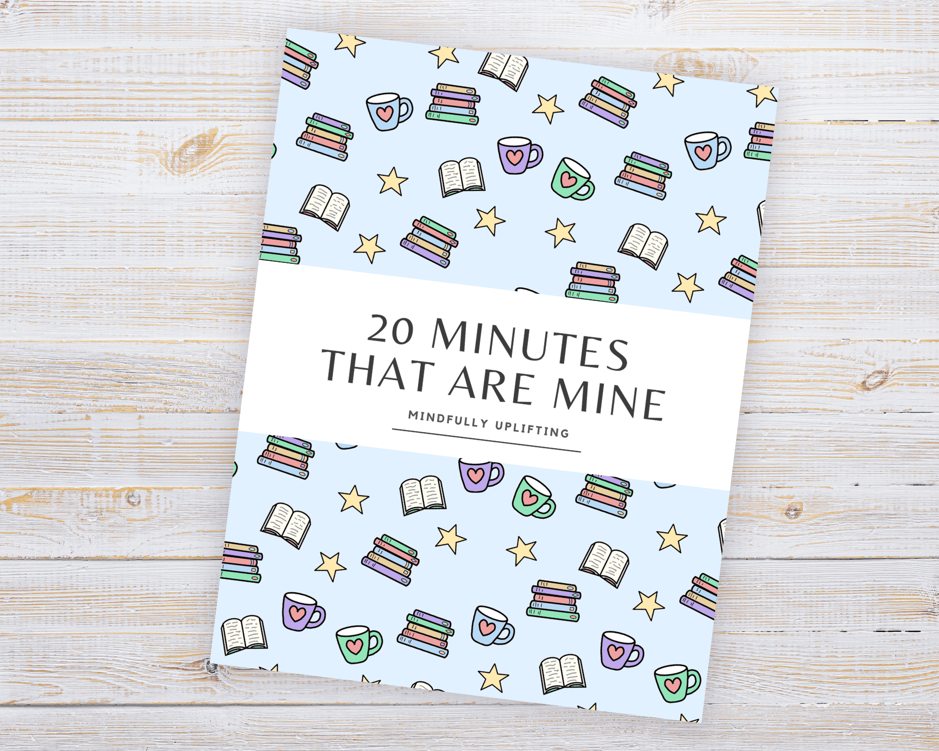 A printed out workbook sits on a wooden table. It has the title "20 Minutes That Are Mine" and is decorated with hand-drawn motifs of cups, books and stars.